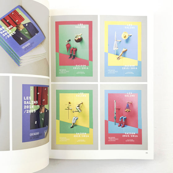 Open book displaying colorful posters with text and images on a white background