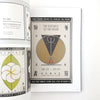 Open book with a design featuring text and geometric shapes on a white background