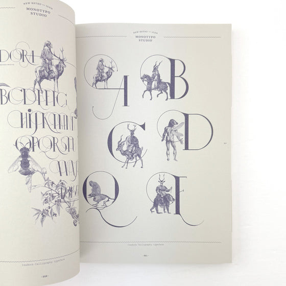 Open book with decorative lettering and illustrations on a white background