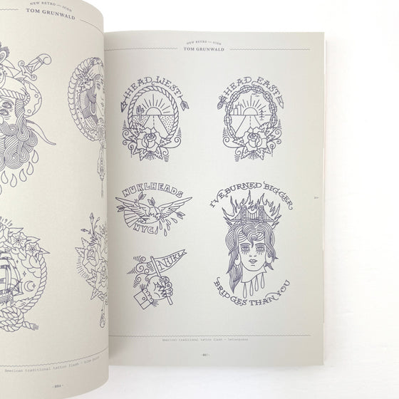 Open book displaying tattoo designs on a white background