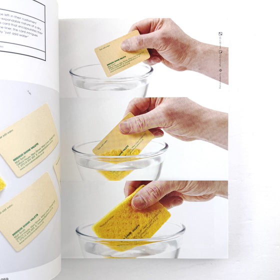 Hands using yellow sponges to clean glass bowls with a white background