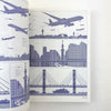 Illustration of airplanes and a city skyline on a book page.