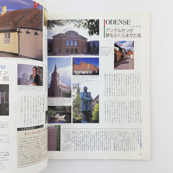 Open book with images and text about Odense, featuring buildings and a statue.